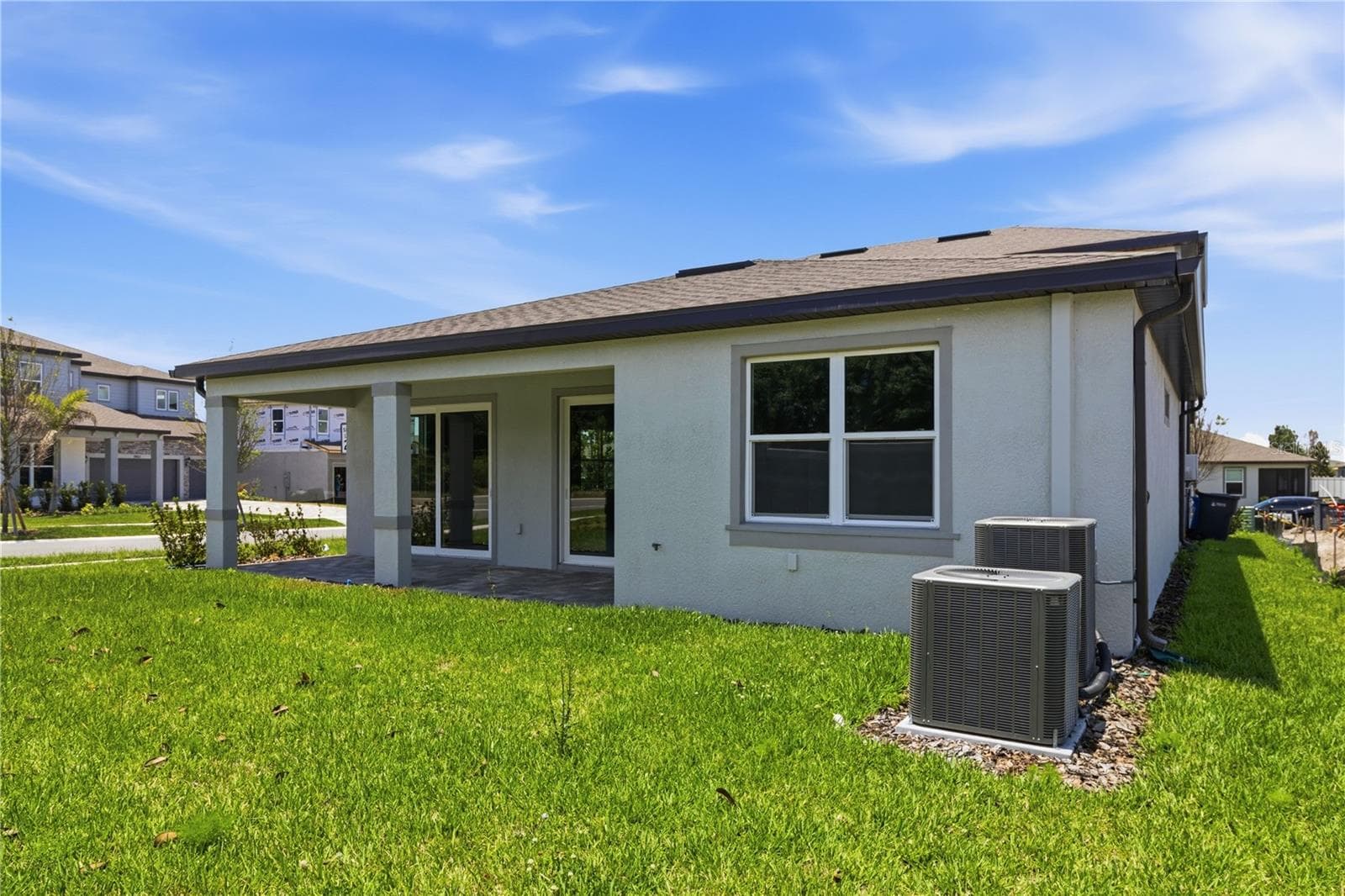 Rear exterior view with covered lanai space and room to enjoy the backyard. - 13824 SUNLIGHT MEADOW DR, RIVERVIEW