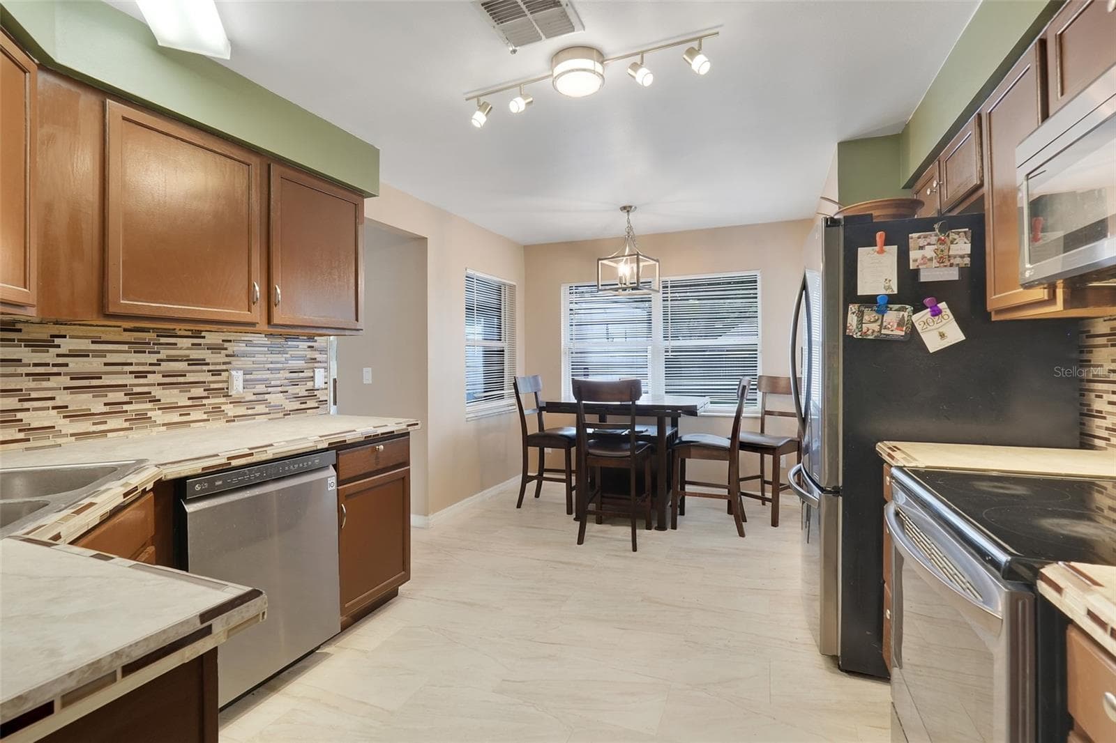 Kitchen with Stone Counters and Backsplash - 10752 CRESCENDO LOOP, CLERMONT