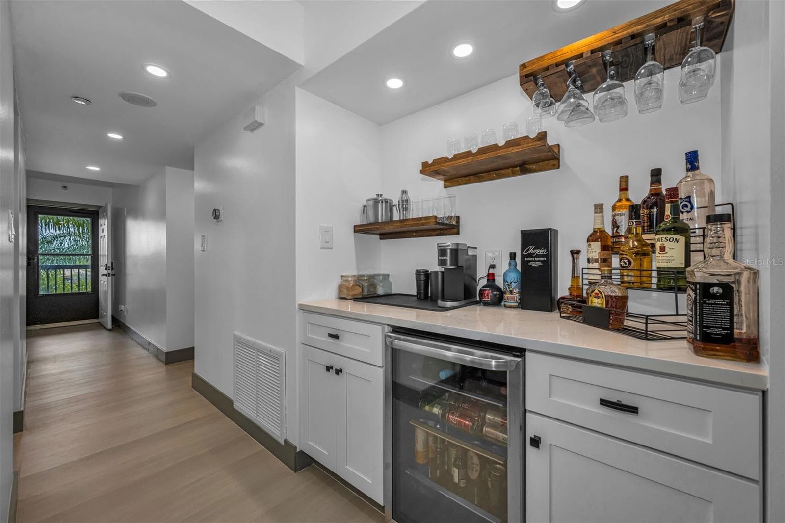 At entrance find luxury vinyl plank flooring throughout.  Dry bar with wine refrigerator with Quartzite counter.  Speccial thermostat on wall to control air conditioning from  where ever you are located. - 5400 PARK ST N #303, ST PETERSBURG