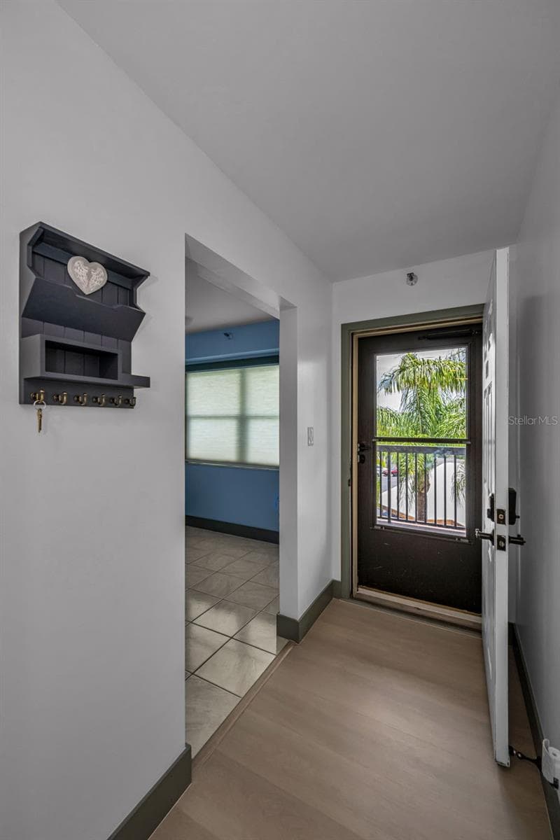 Entrance with bonus room to right.  Luxury random plank flooring throughout. - 5400 PARK ST N #303, ST PETERSBURG
