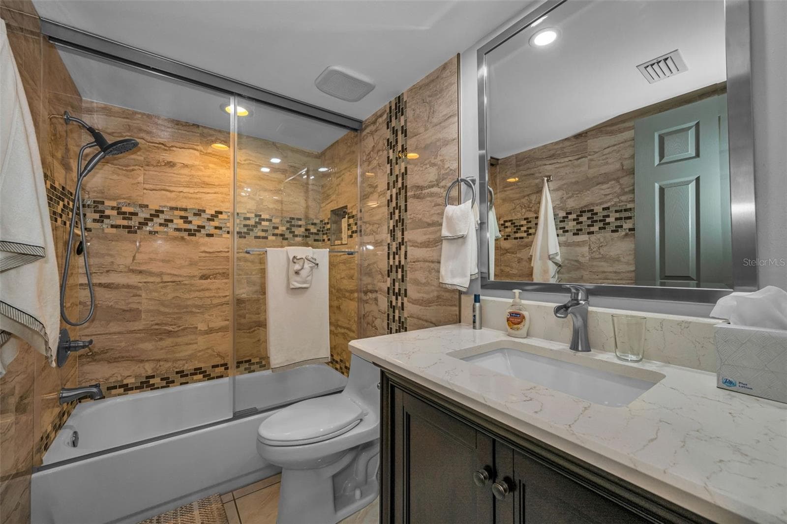 New vanity, tub tile, glass doors, exhaust in this Bathroom. - 5400 PARK ST N #303, ST PETERSBURG