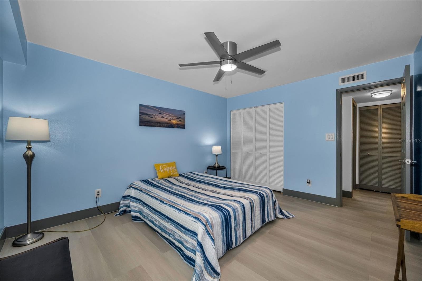 Second bedroom with double closet and new fan. - 5400 PARK ST N #303, ST PETERSBURG