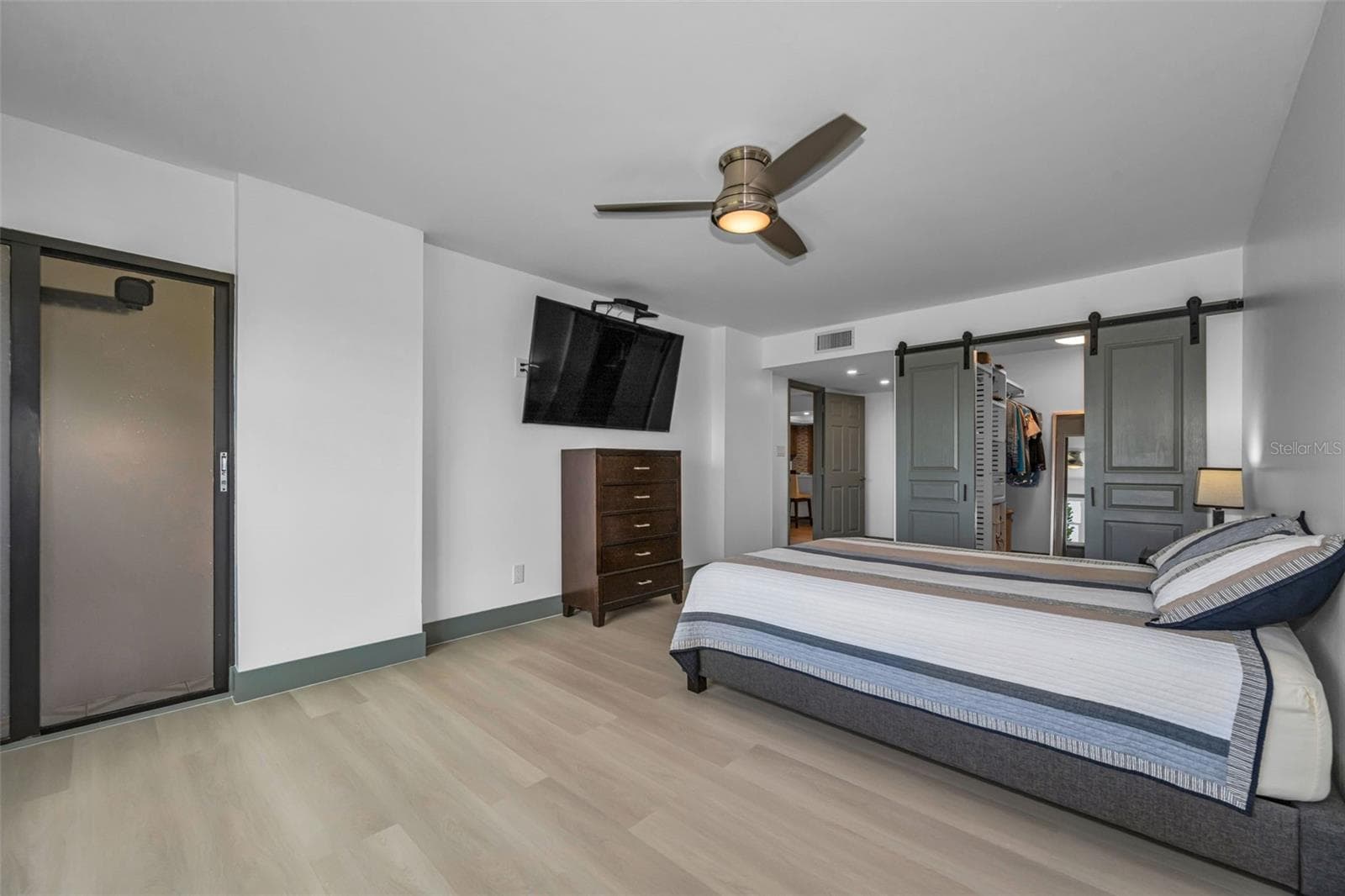 Primary bedroom with special closet sliding doors, and door to Balcony. - 5400 PARK ST N #303, ST PETERSBURG