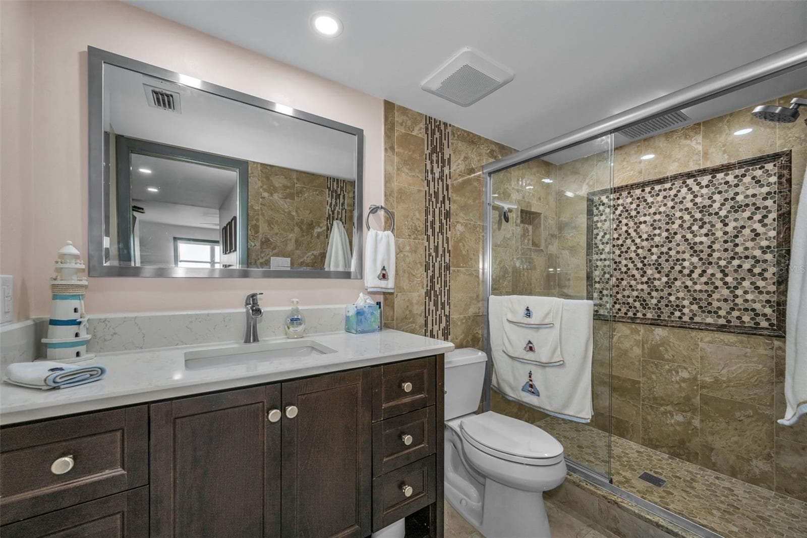 Primary Bathroom with new shower, toilet and vanity, plus overhead lighting.  Gorgeous. - 5400 PARK ST N #303, ST PETERSBURG