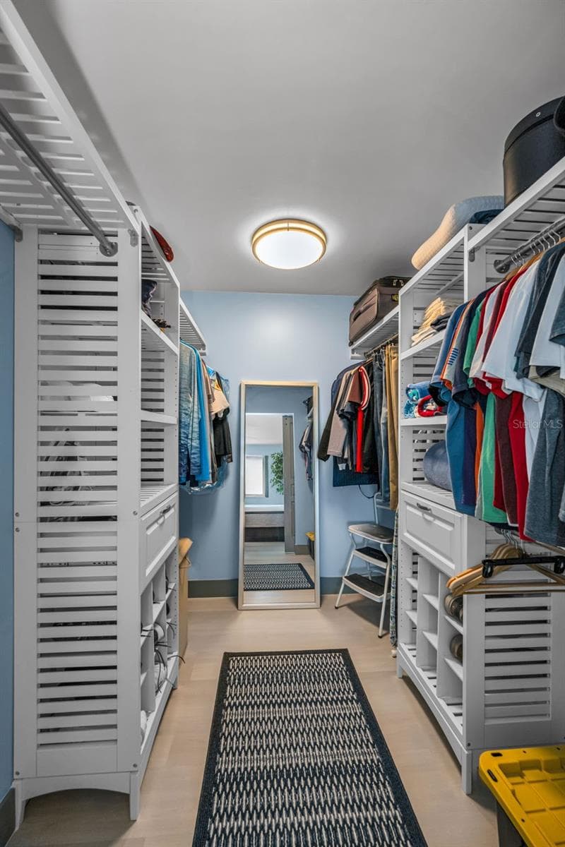 Top of the line custom closet built-out in style in Primary Bedroom. - 5400 PARK ST N #303, ST PETERSBURG