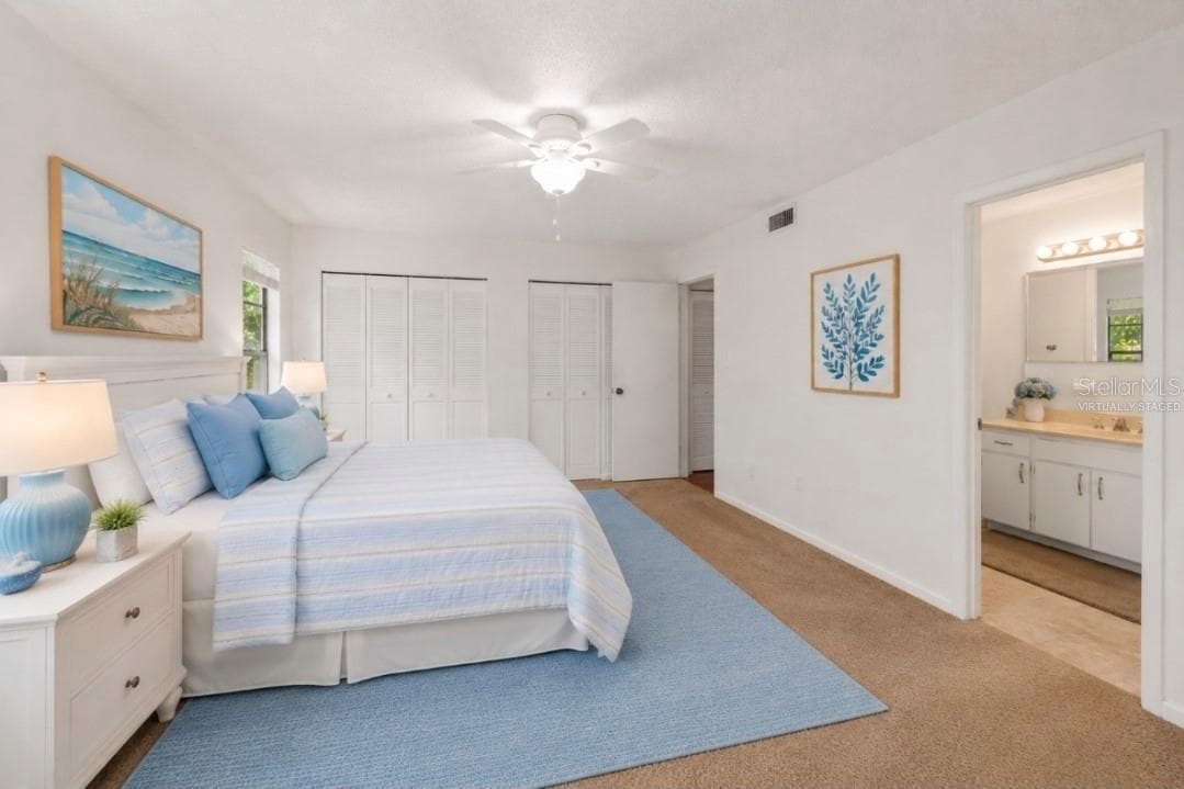 Primary bedroom, view to private bathroom(Partially virtually staged - 2415 NE 7TH ST #8, OCALA