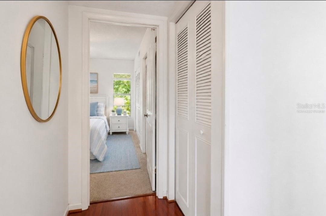 Hall way view to primary bedroom and linen closet(Partially virtually staged. - 2415 NE 7TH ST #8, OCALA