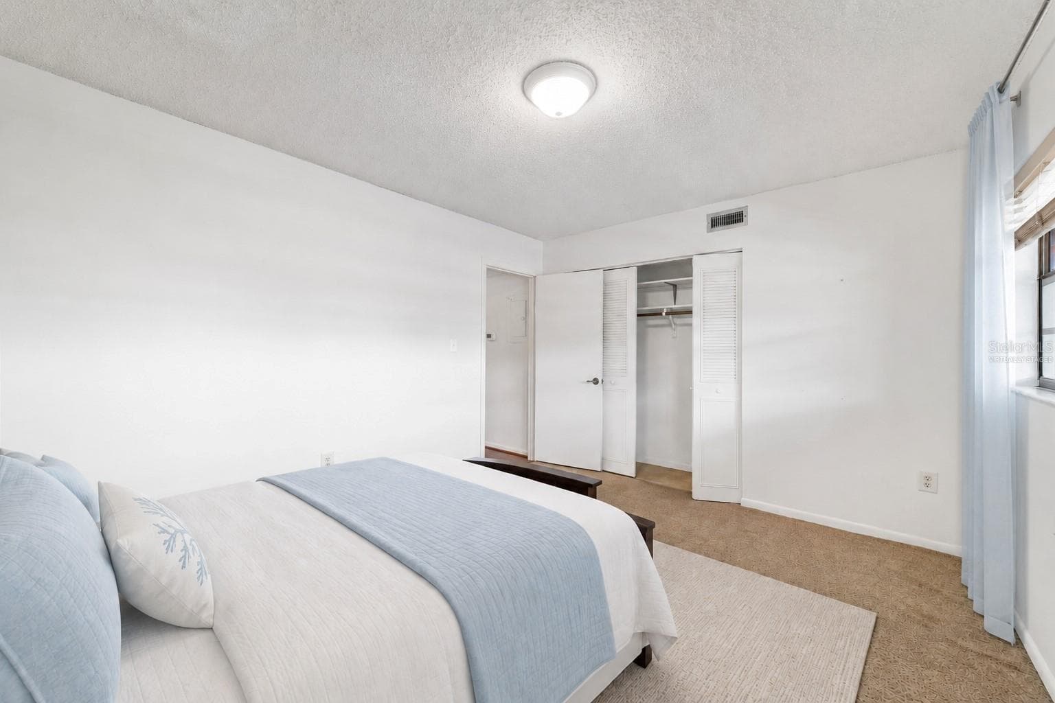 Guest bedroom, looking to cost(Partially virtually staged - 2415 NE 7TH ST #8, OCALA