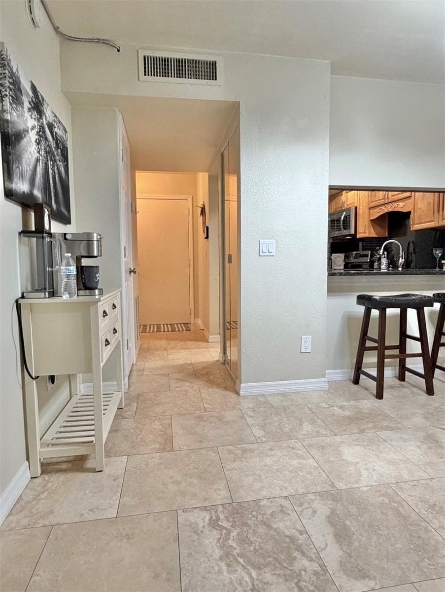 Travertine floors are throughout the living room, the kitchen and hallways. - 3815 N OAK DR #G71, TAMPA