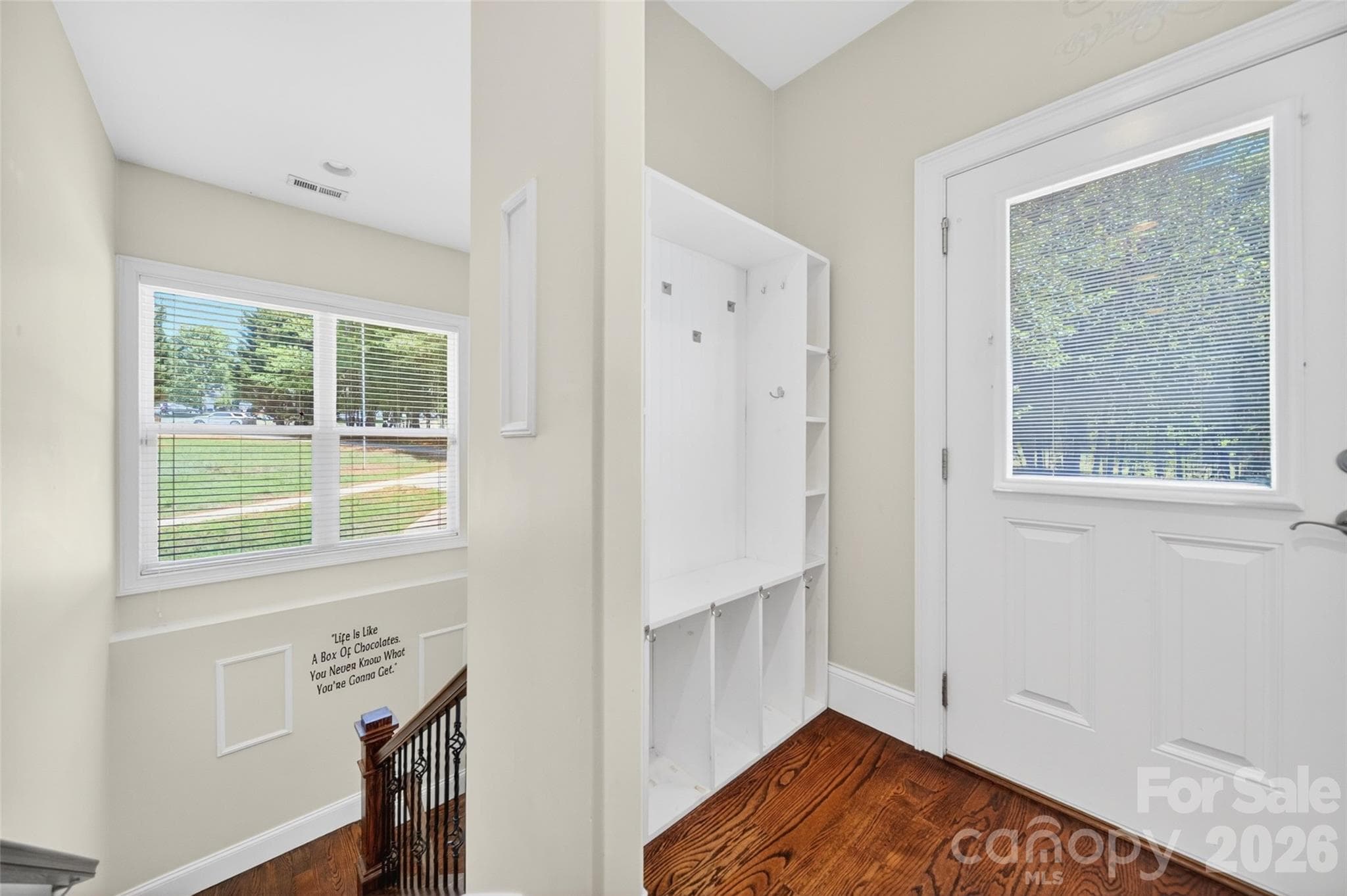 Side entry door with drop zone and wide hardwood steps down to the basement. - 2977 Cabin Creek Drive, Catawba
