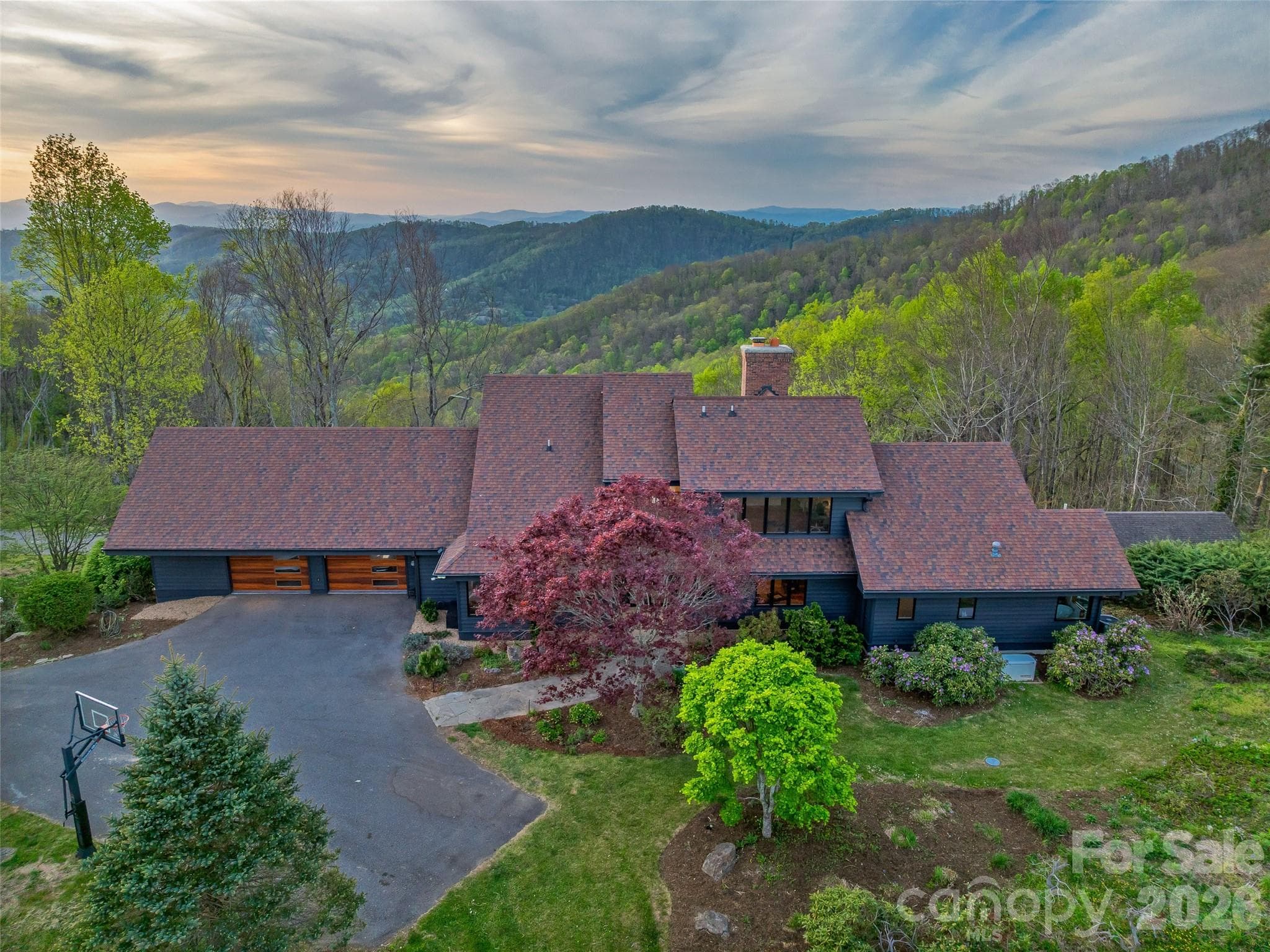 Thoughtful landscape design features native Rhododendron, Japanese maples, flowering cherry trees, hydrangeas and more. - 100 Big Spring Drive, Asheville