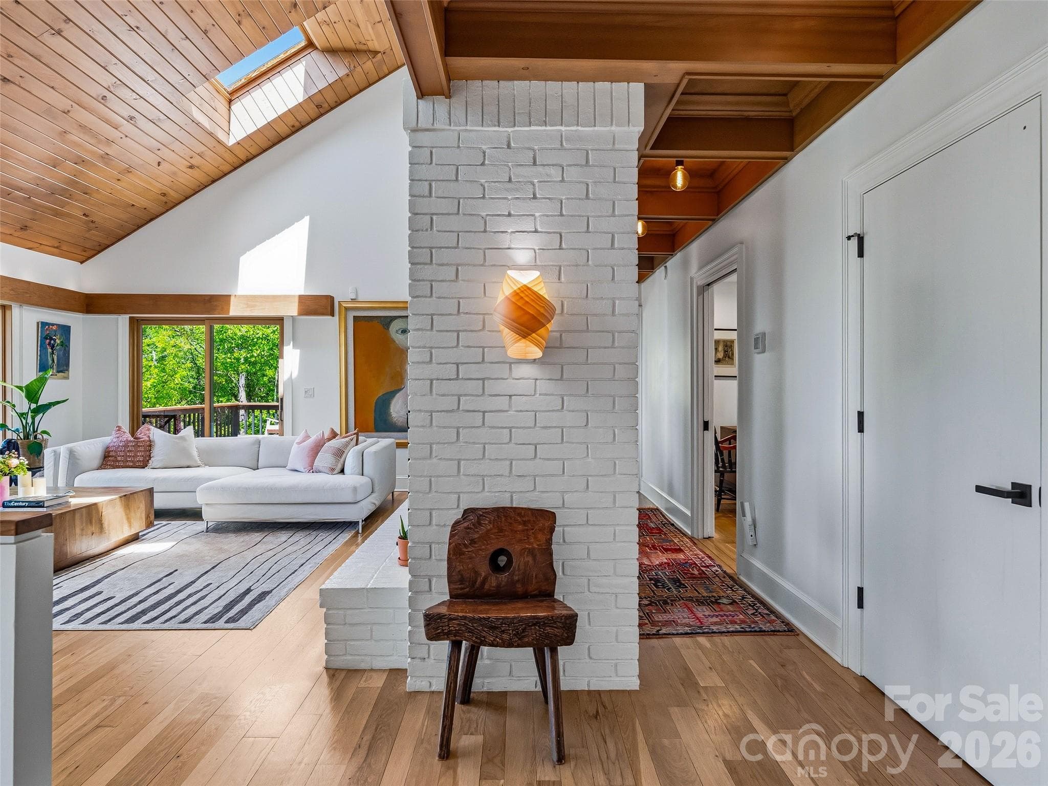 The foyer leads to a spacious yet cozygreat room with vaulted knotty pine ceilings. - 100 Big Spring Drive, Asheville