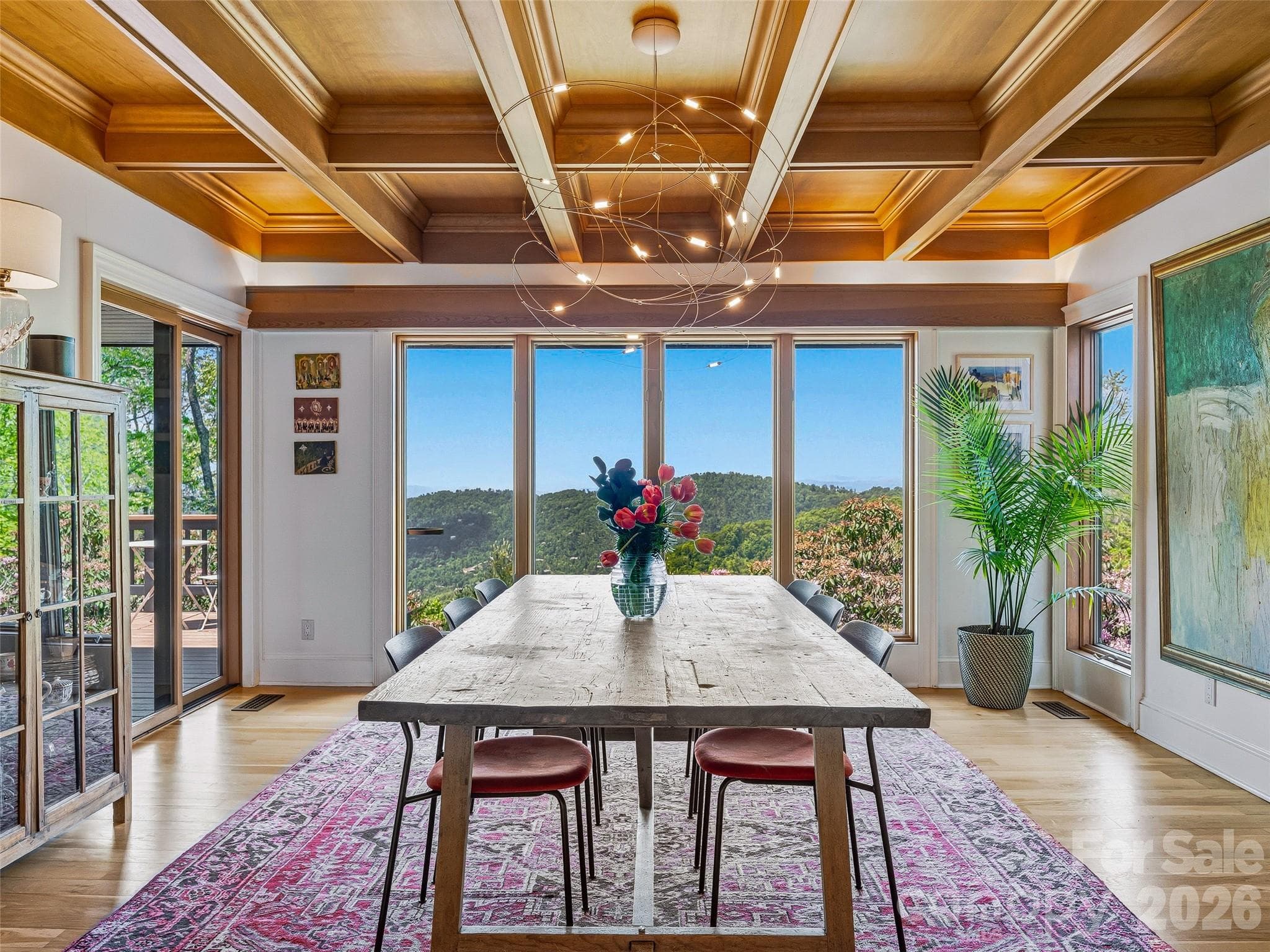 The dining area offers more long-range layered northwest views, and sliding glass doors leading to a deck perfect for grilling, entertaining, and dining al fresco. - 100 Big Spring Drive, Asheville