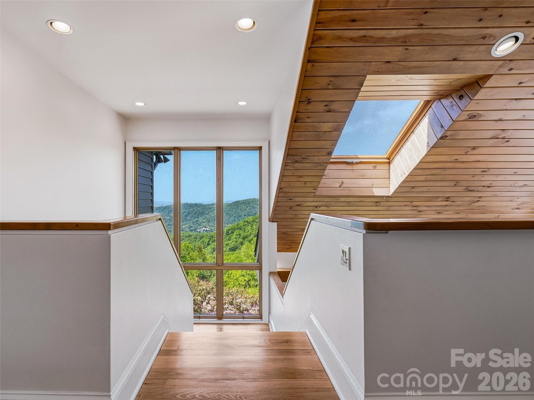 Skylights and clerestory windows bathe light on every aspect of the home, even the architecturally striking stairwells. - 100 Big Spring Drive, Asheville