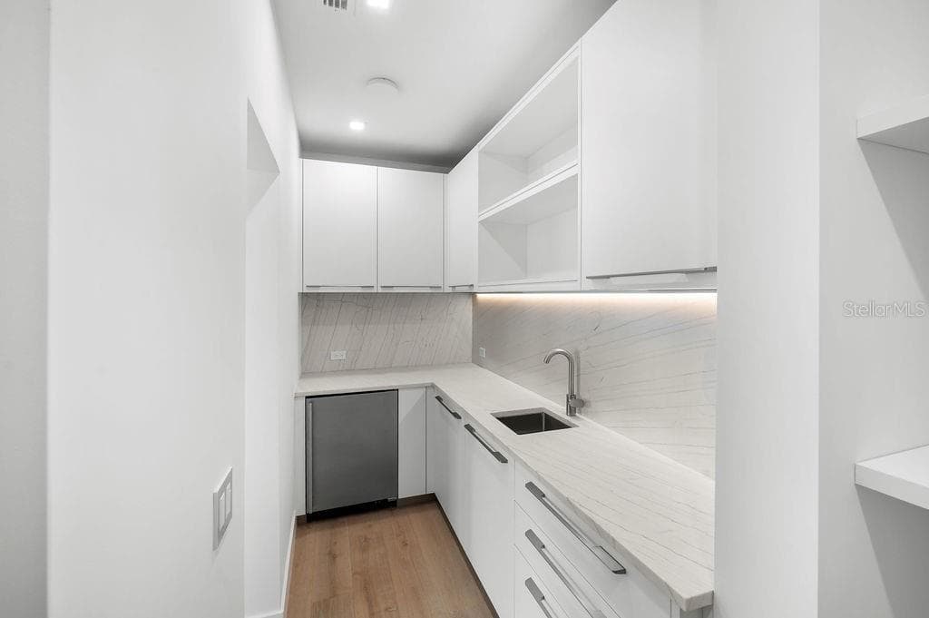 Kitchen hosts a hidden scullery with built in shelving and additional refrigeration - 6489 GULFSIDE RD, LONGBOAT KEY