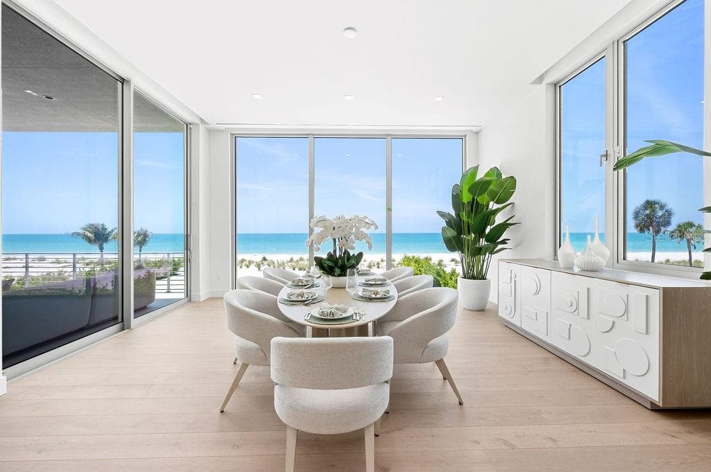 Dining area is surrounded by 11 foot impact glass windows and sliders - 6489 GULFSIDE RD, LONGBOAT KEY