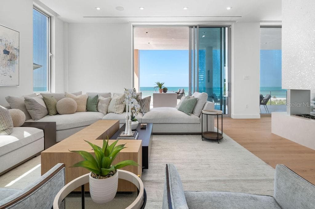 Second living space shares the two-sided vapor fireplace space adjacent to the Summer kitchen. - 6489 GULFSIDE RD, LONGBOAT KEY