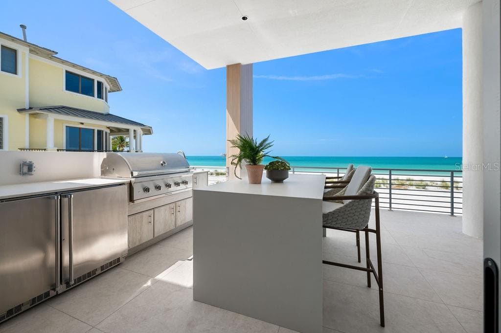 Enjoy the Summer kitchen with Coyote™ gas grill, refridgerator and sink. - 6489 GULFSIDE RD, LONGBOAT KEY