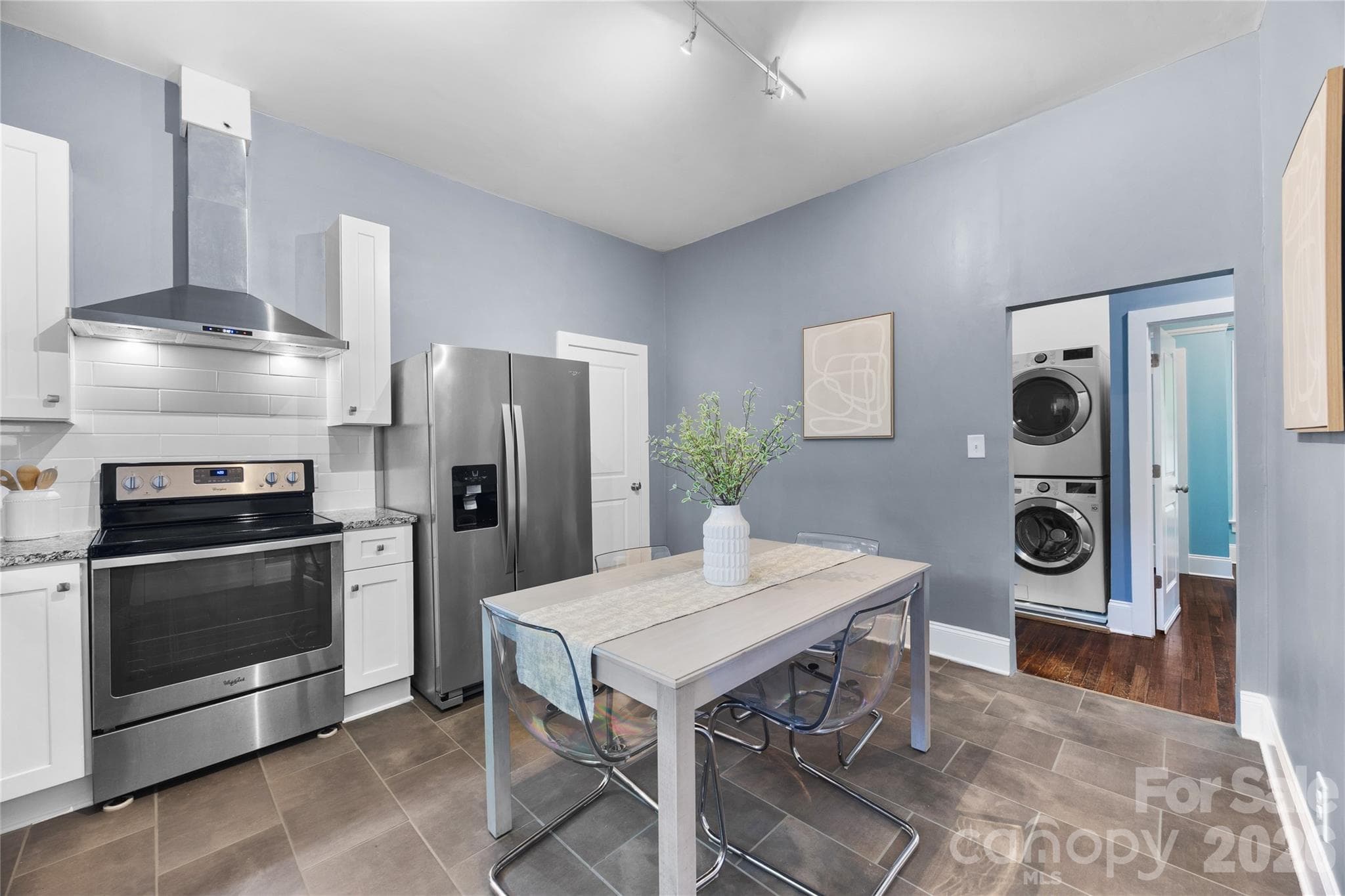 Thoughtfully redesigned kitchen offering an open feel, timeless finishes, and plenty of room to spread out and entertain. - Charlotte