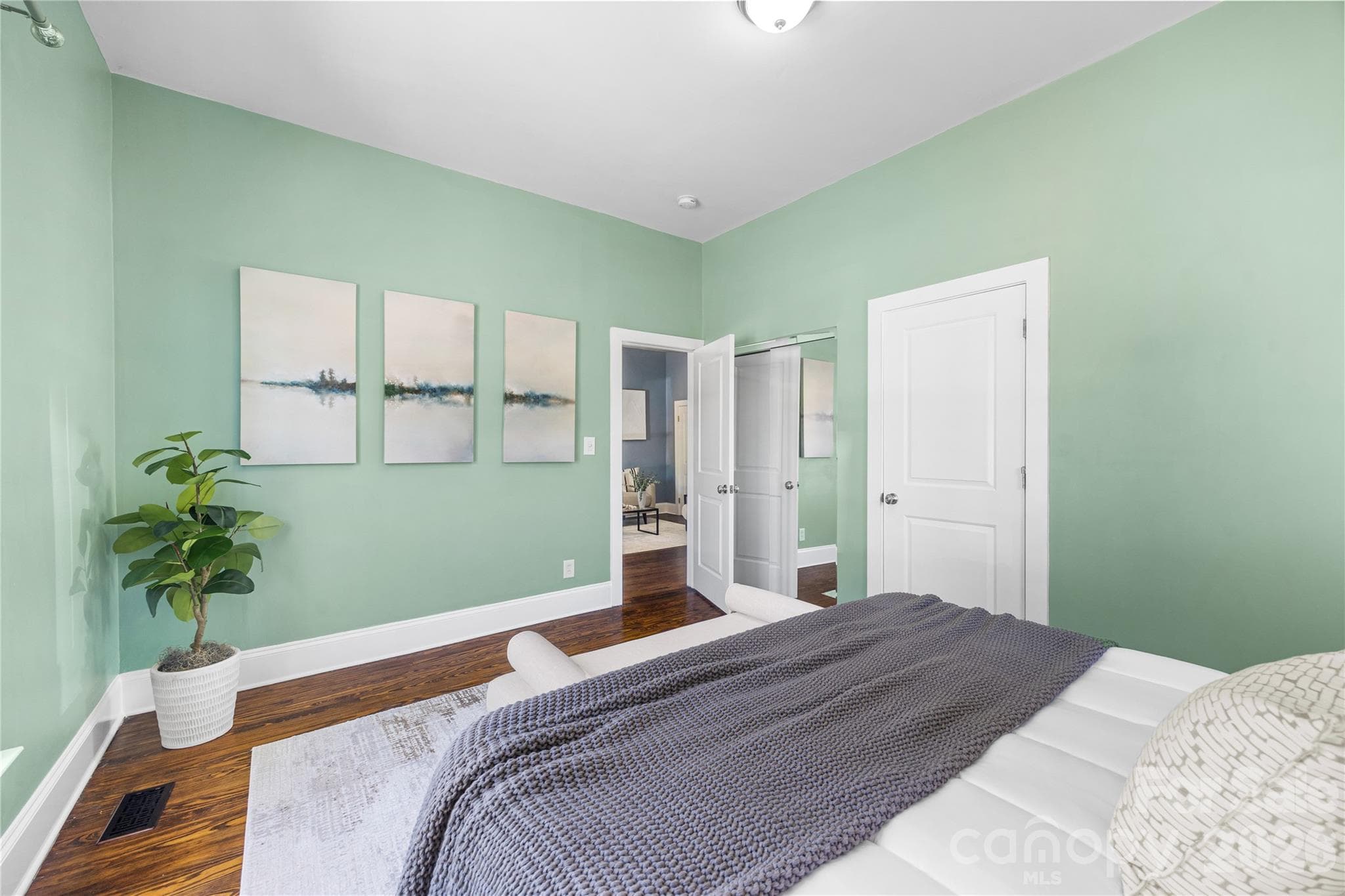 Primary bedroom is spacious with hardwood floors, natural light and high ceilings. - Charlotte