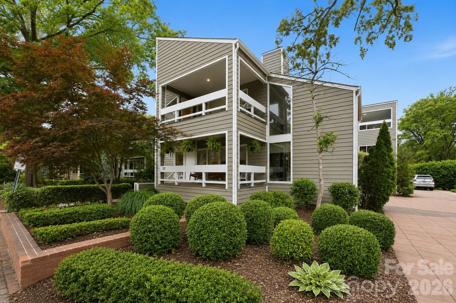 Striking contemporary façade surrounded by mature landscaping - Charlotte