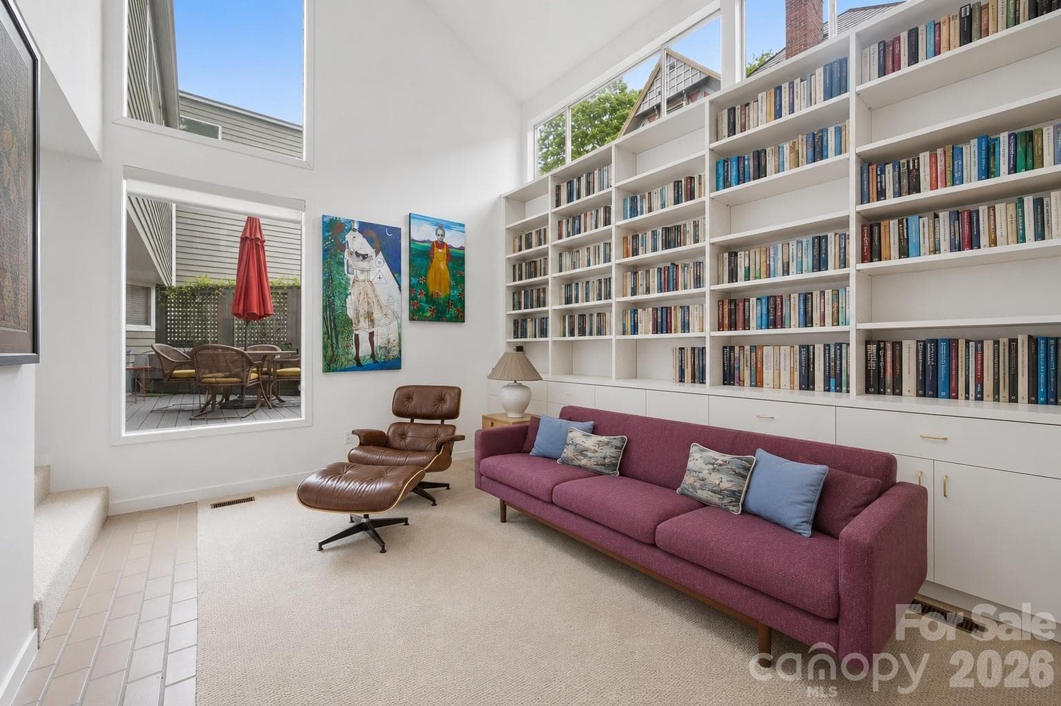 Sunlit library space filled with warmth, openness, and architectural character - Charlotte