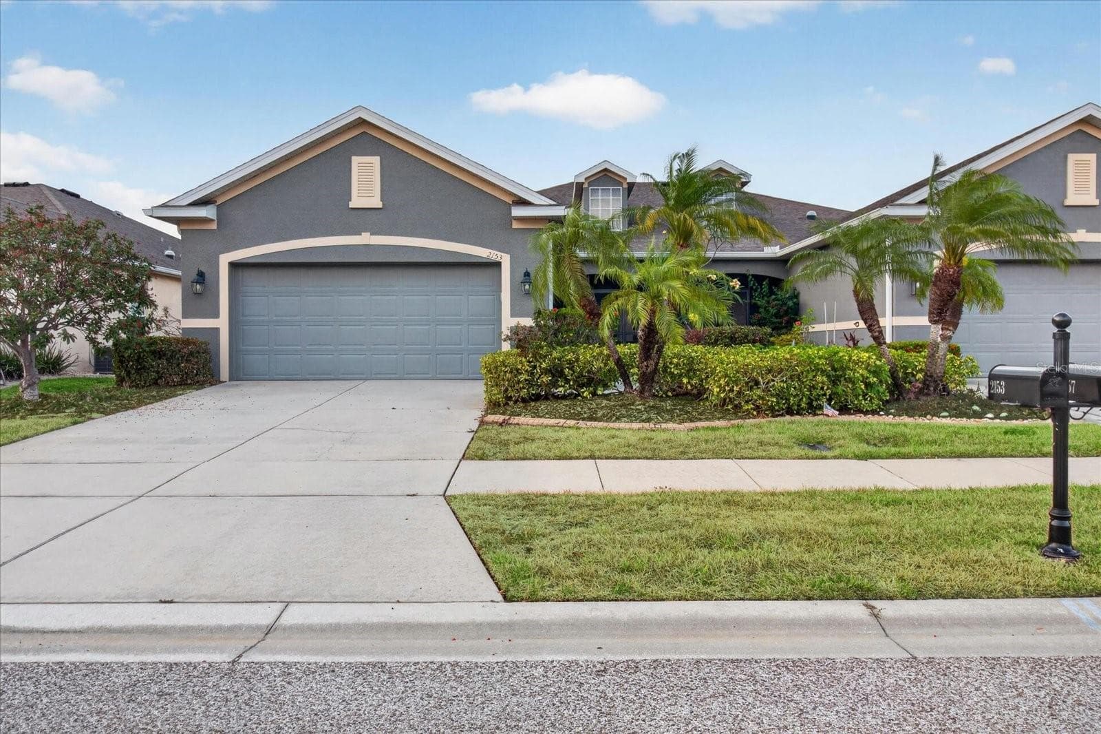 Additional front exterior view of this Gulfwinds villa and its two-car garage. - 2153 BARRACUDA CT, HOLIDAY