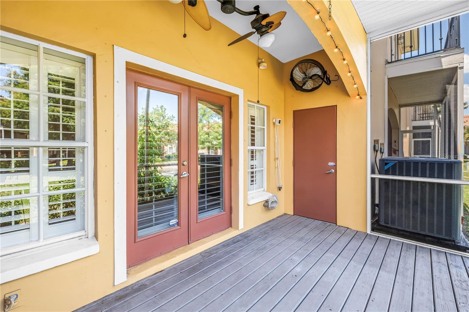 Screened and covered porch overlooking the pond with storage closet - 409 BARCELONA DR, ST PETERSBURG