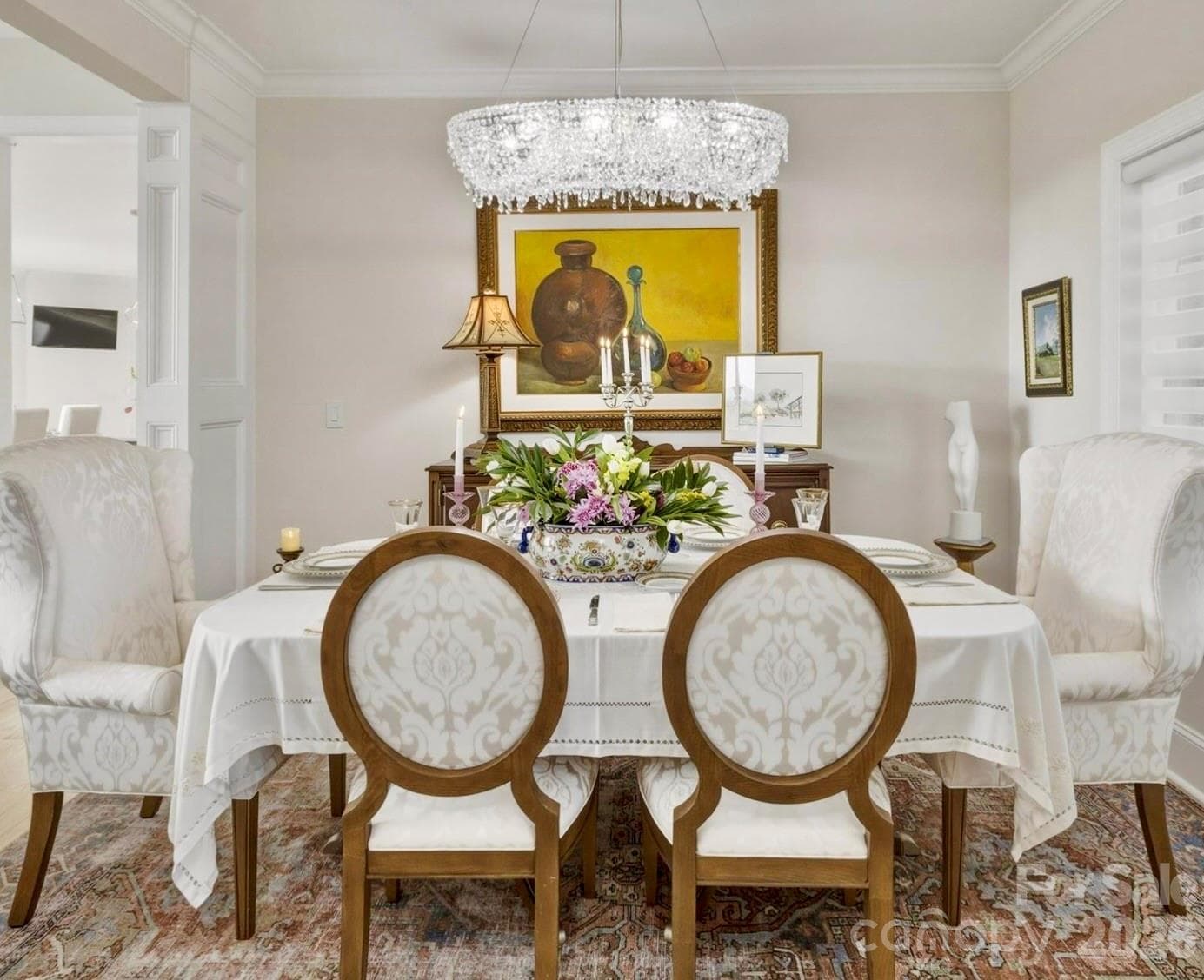In the formal dining room, elegant architectural details complement the crystal chandelier’s brilliance. - Lenoir