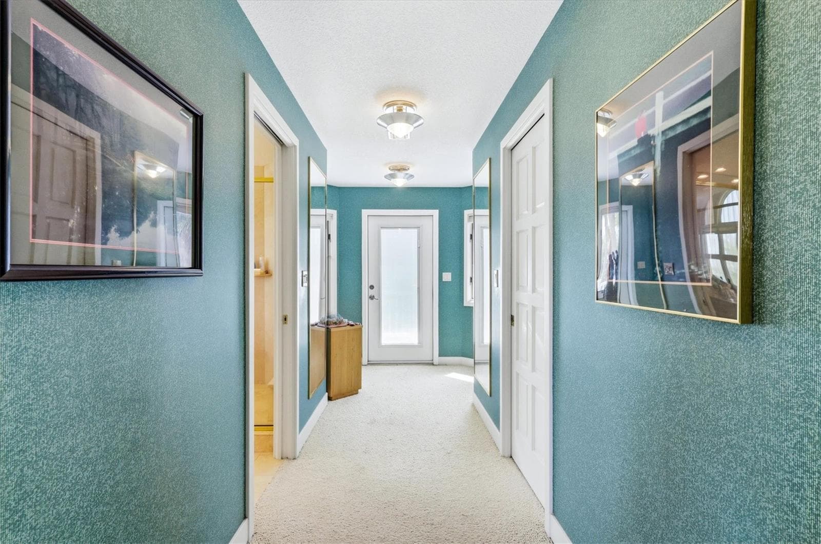 Hallway in Master Suite leads to a walk-in closet and Master Bath - 750 N MANASOTA KEY RD, ENGLEWOOD