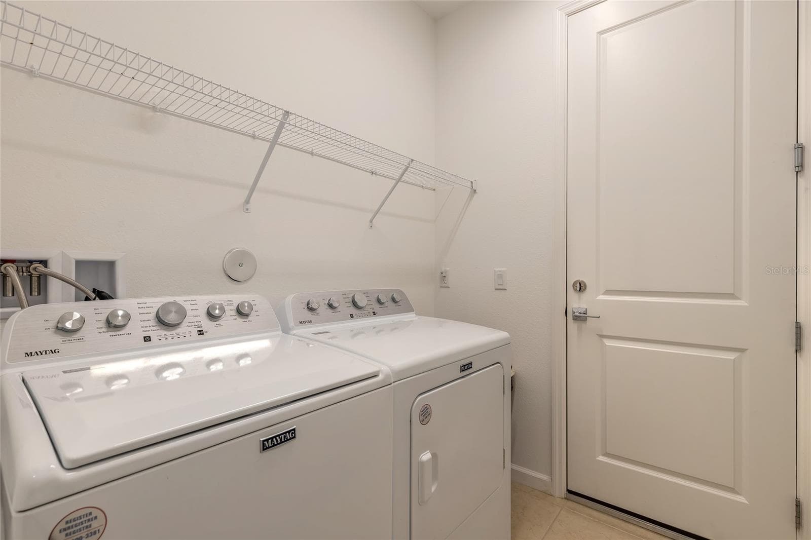 Laundry room that leads to the garage - 230 SAND BAR LN, DAYTONA BEACH