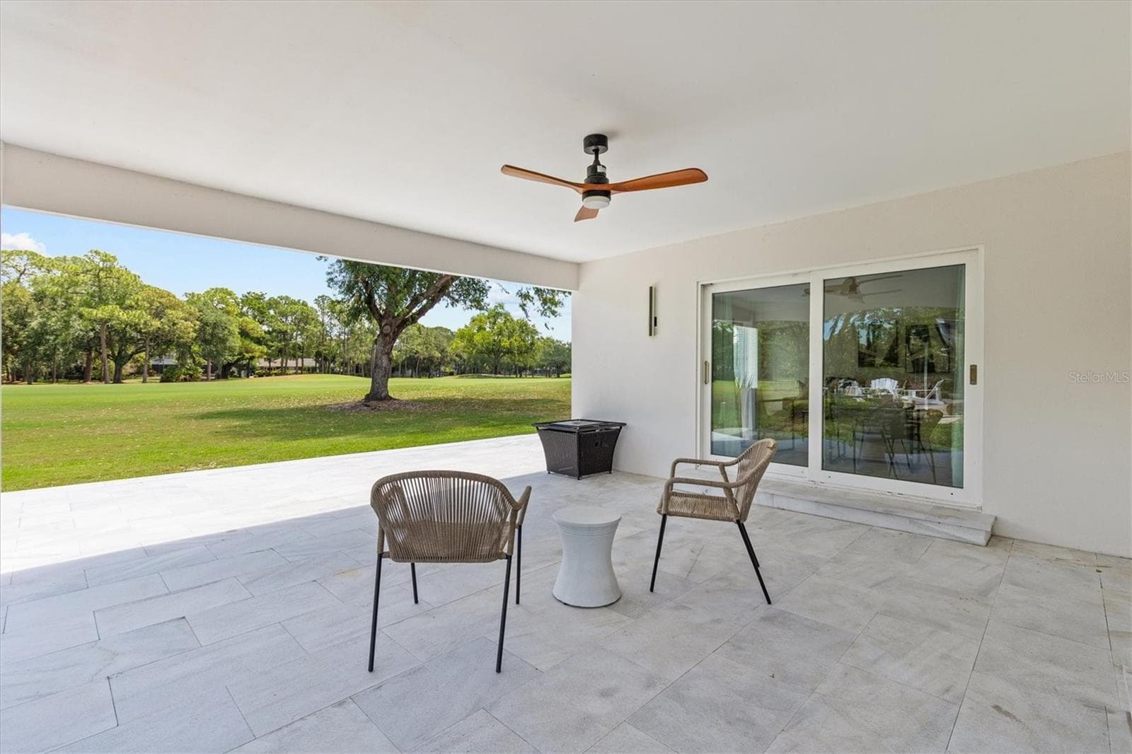 Outdoor lanai overlooking golf course - 13915 WHISPERWOOD DR, CLEARWATER