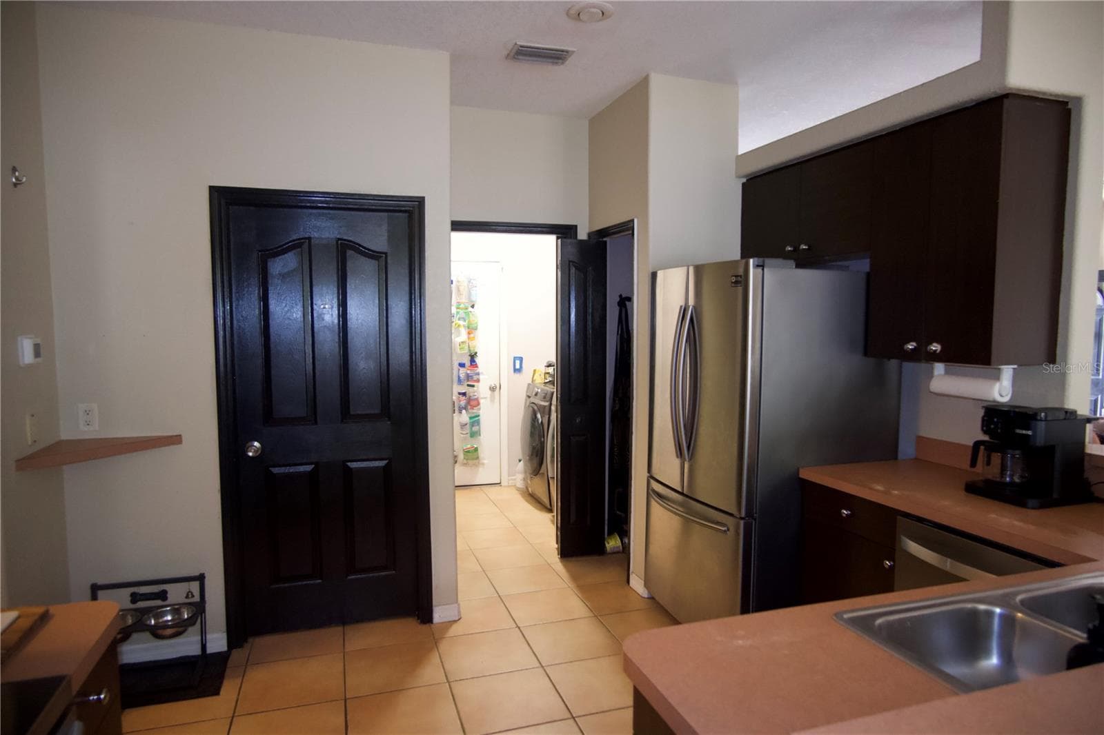 Kitchen with view into the laundry room, door leads to the second bathroom - 4491 CUTHBERT AVE, NORTH PORT