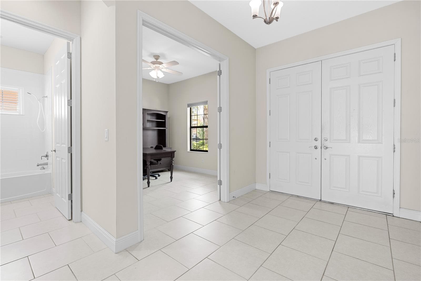 front door entry with view of office and downstairs guest bathroom - 13830 MOONSTONE CANYON DR, RIVERVIEW