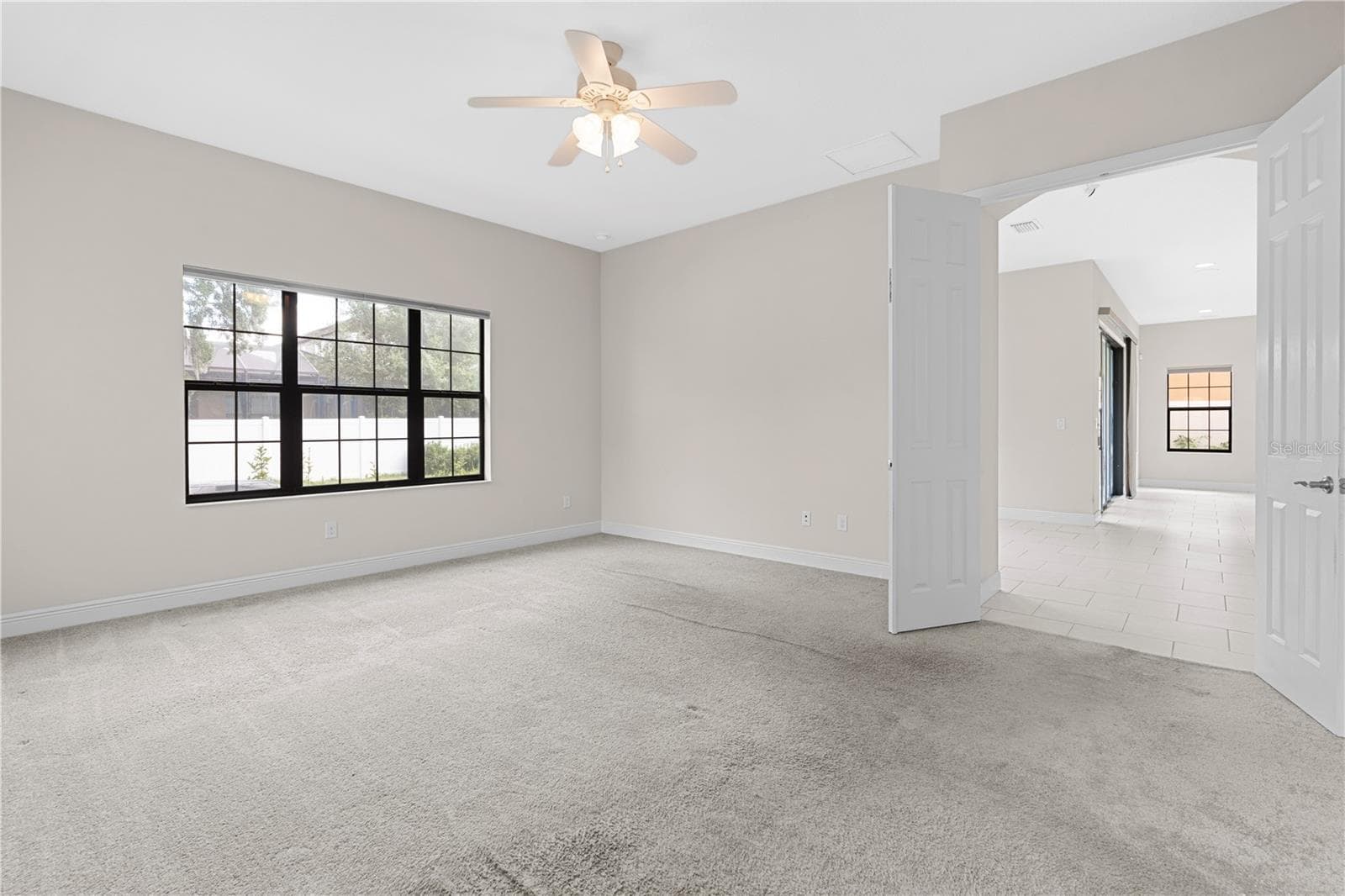 downstairs master bedroom with french doors - 13830 MOONSTONE CANYON DR, RIVERVIEW