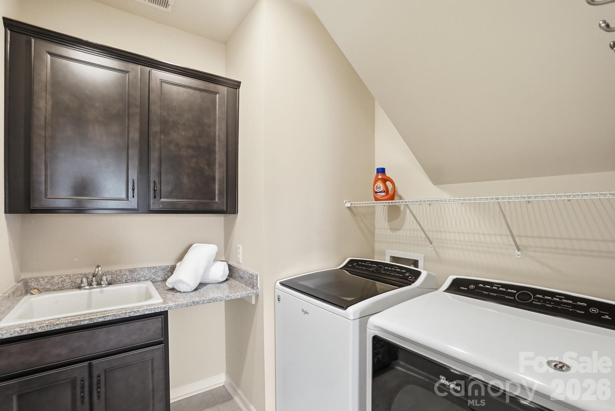 A huge laundry room with tons of cabinetry and plenty of space to keep everything organized! - 2331 Currant Street, Fort Mill