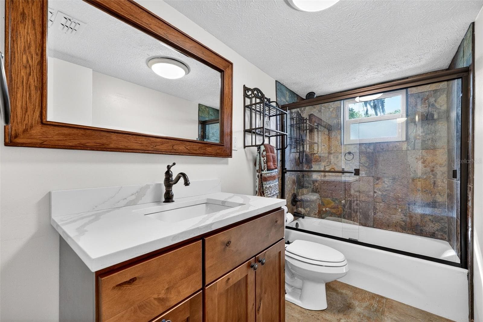 Second floor bath. Tub/shower combo with rain head shower head. - 19801 GUNN HWY, ODESSA