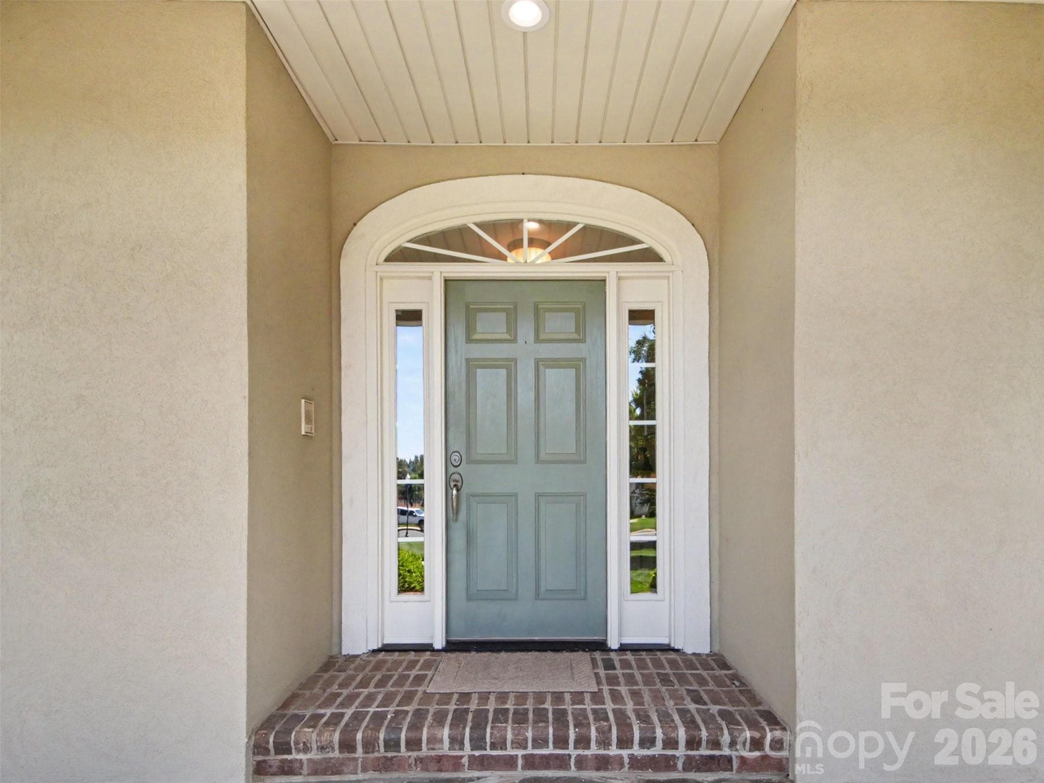The front door with a beautiful arched casing is very inviting! - 1422 Stone Gate Drive, Shelby
