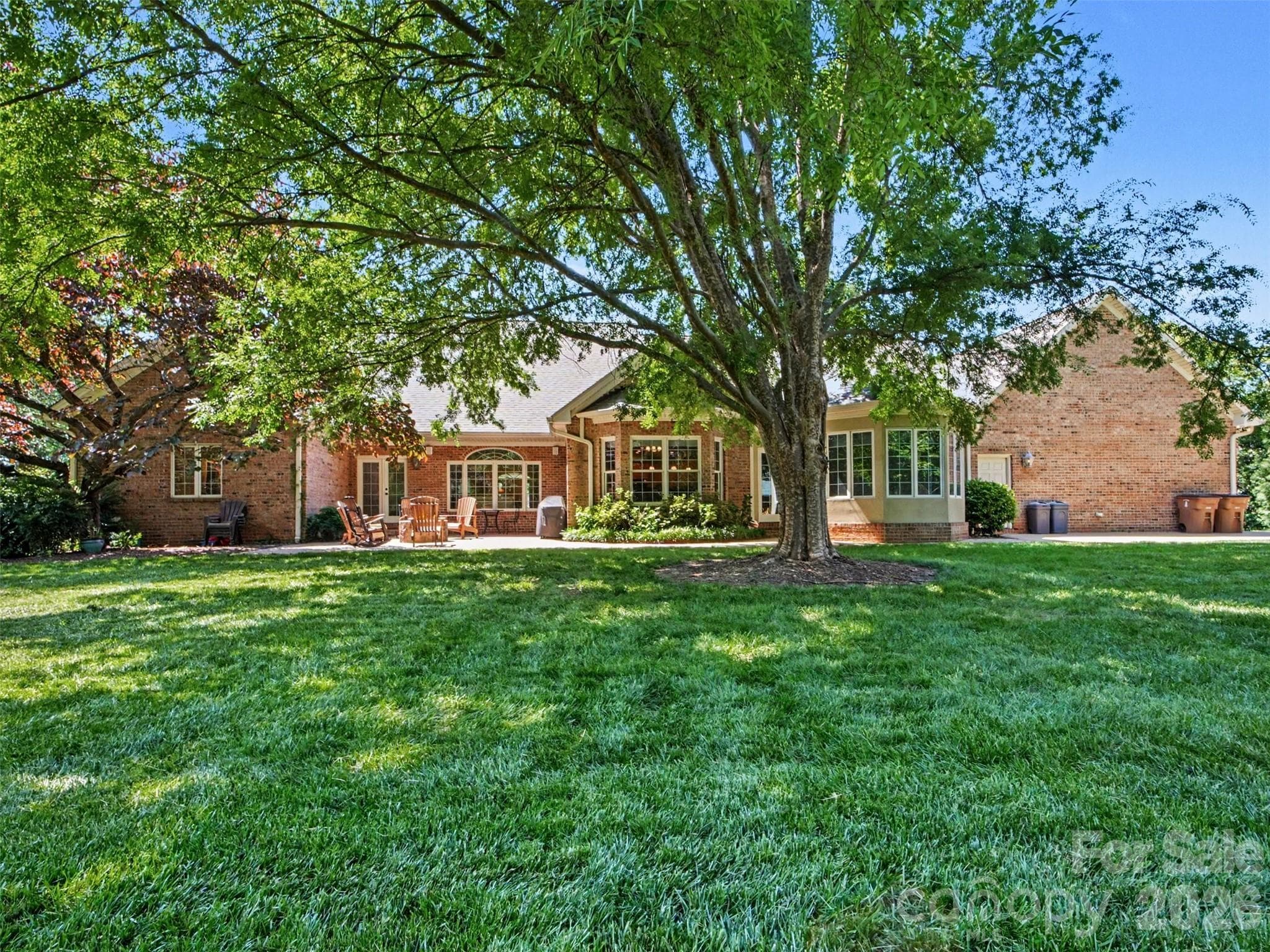 Patio with fire pit is accessed from primary bedroom, kitchen, and sunroom!  Wonderful outdoor living area! - 1422 Stone Gate Drive, Shelby
