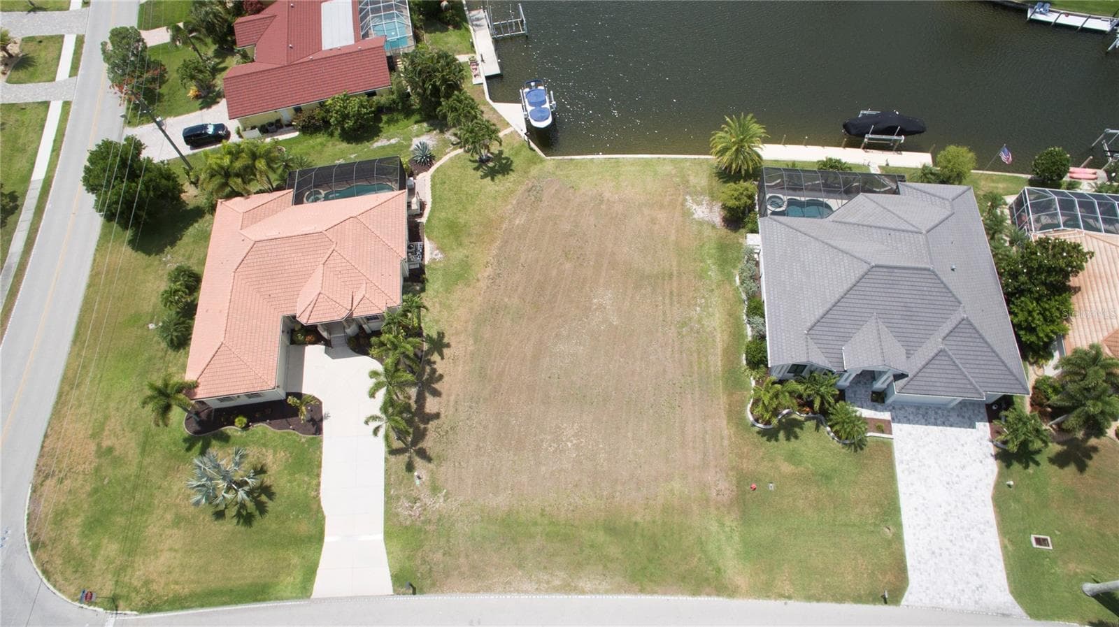 The lot is next to the corner home at Monaco Dr and Madrid Blvd. - 507 MADRID BLVD, PUNTA GORDA