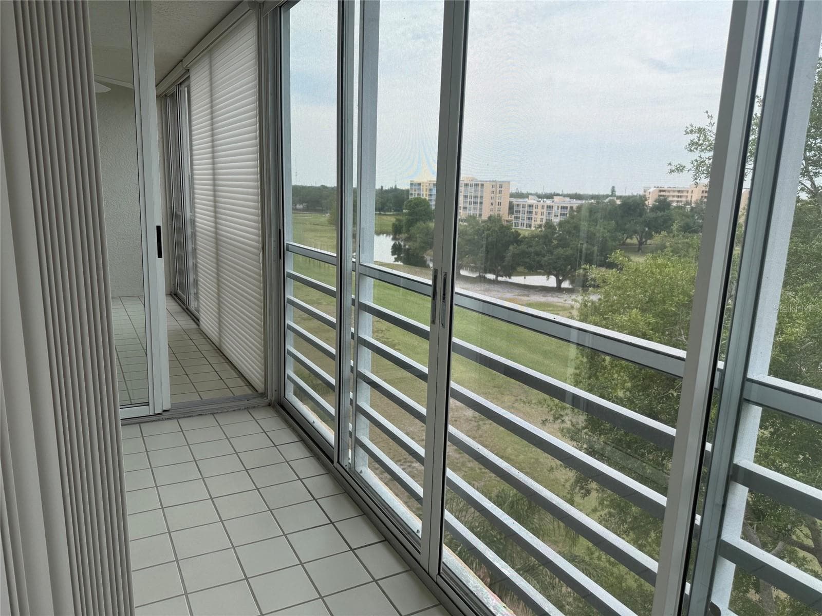 Separate glass and screen enclosed lanai for primary bedroom. There's a sliding door that separates the primary bedroom lanai from the one off of the living room. - 3740 PINEBROOK CIR #607, BRADENTON