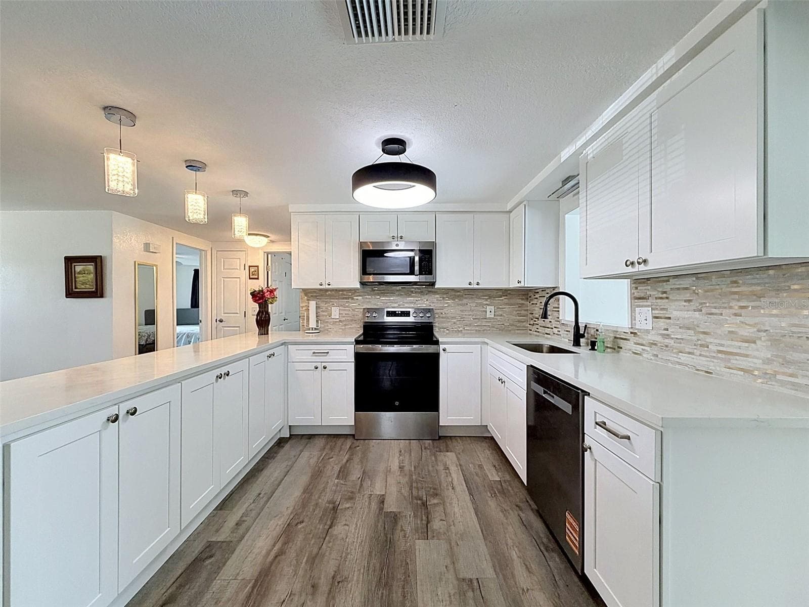 Stainless steel appliances and abundant prep space. - 12735 1ST ISLE, HUDSON