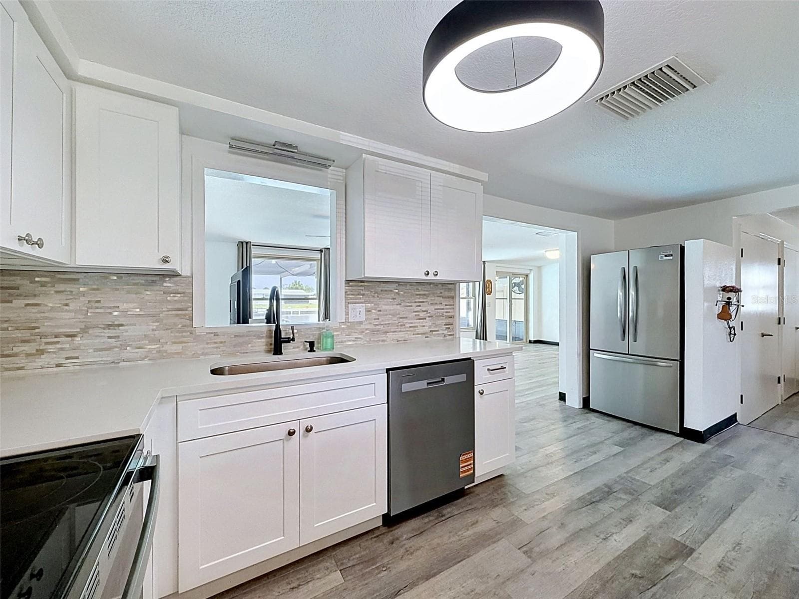 Beautiful white cabinetry brightens the kitchen space. - 12735 1ST ISLE, HUDSON