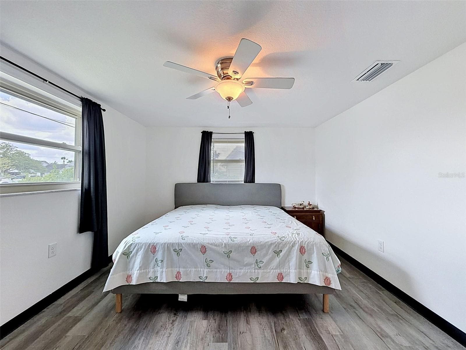 Spacious guest bedroom with abundant natural light. - 12735 1ST ISLE, HUDSON