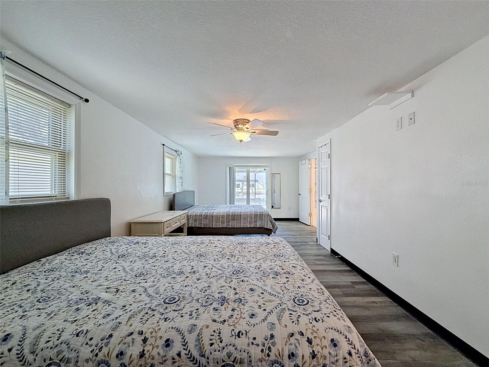Sliding glass doors provide direct access to the pool area. - 12735 1ST ISLE, HUDSON