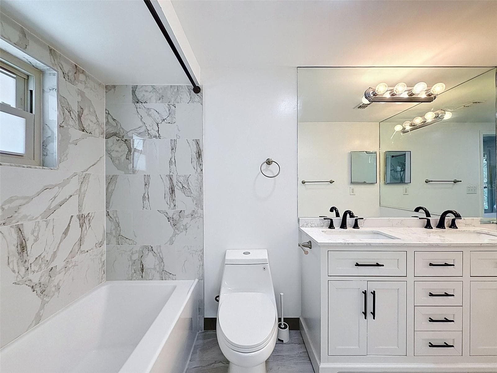 Thoughtfully updated bathroom with stylish coastal finishes. - 12735 1ST ISLE, HUDSON