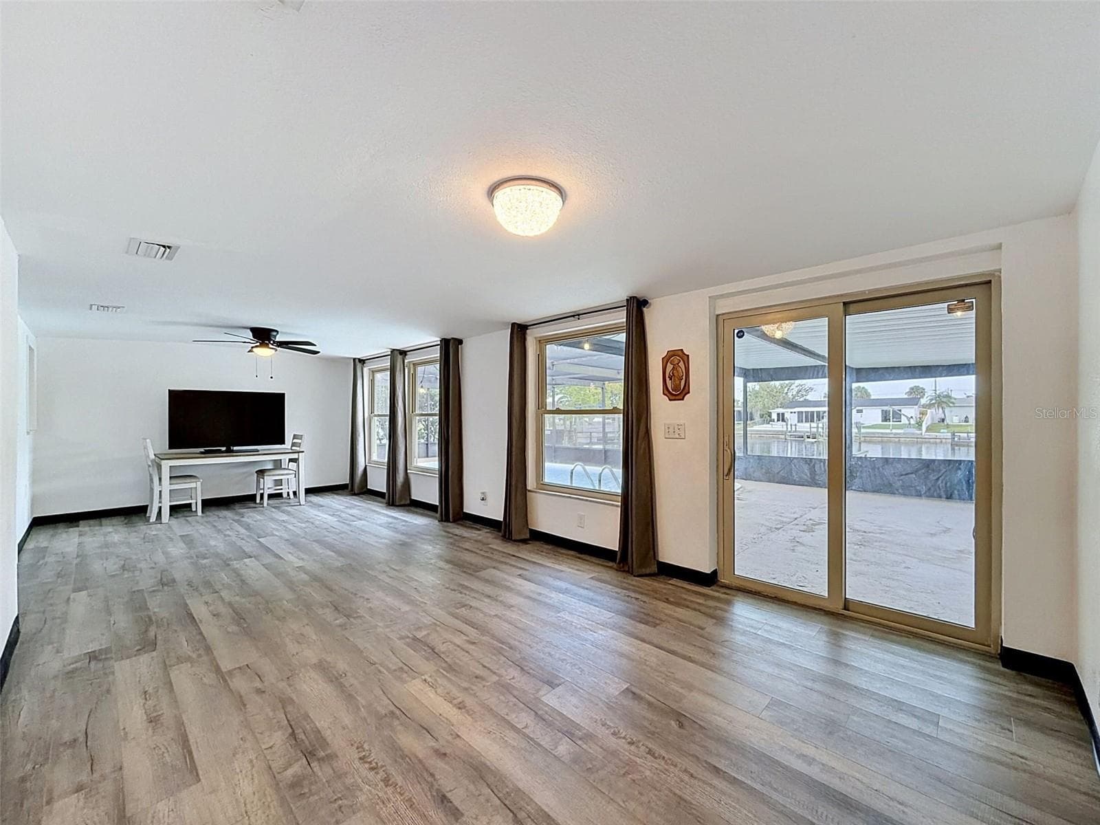 Spacious gathering room with direct pool access. - 12735 1ST ISLE, HUDSON