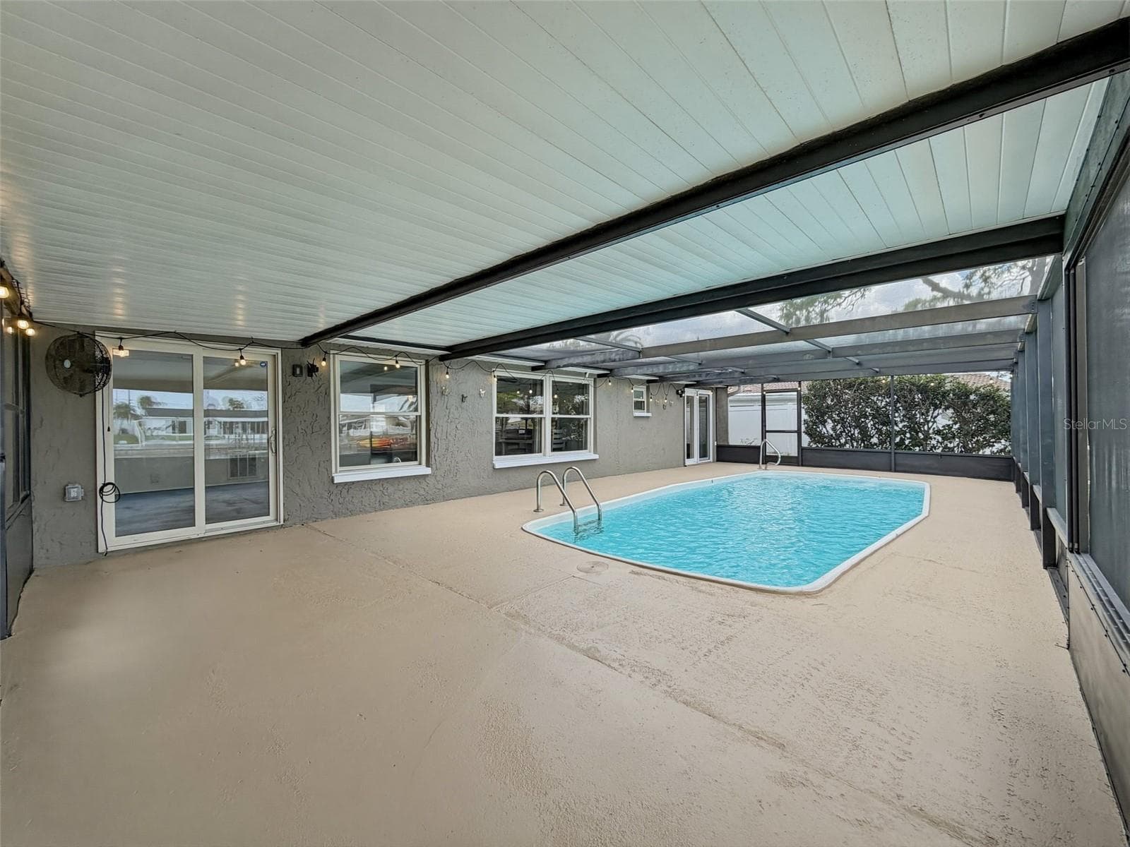 Screened-in pool area designed for year-round enjoyment. - 12735 1ST ISLE, HUDSON