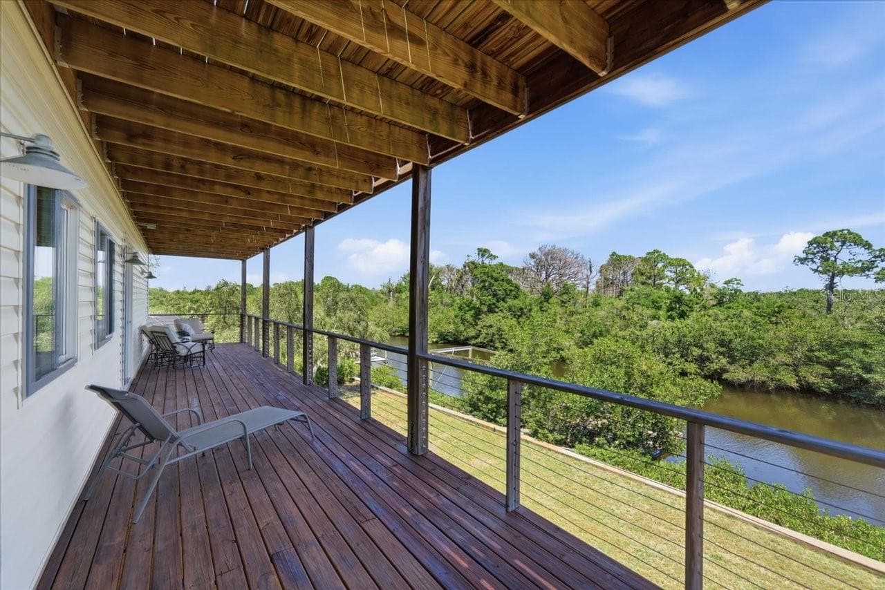 Covered balcony/deck 2nd level- Primary and 3rd bedroom Access - 1130 S FLORIDA AVE, TARPON SPRINGS