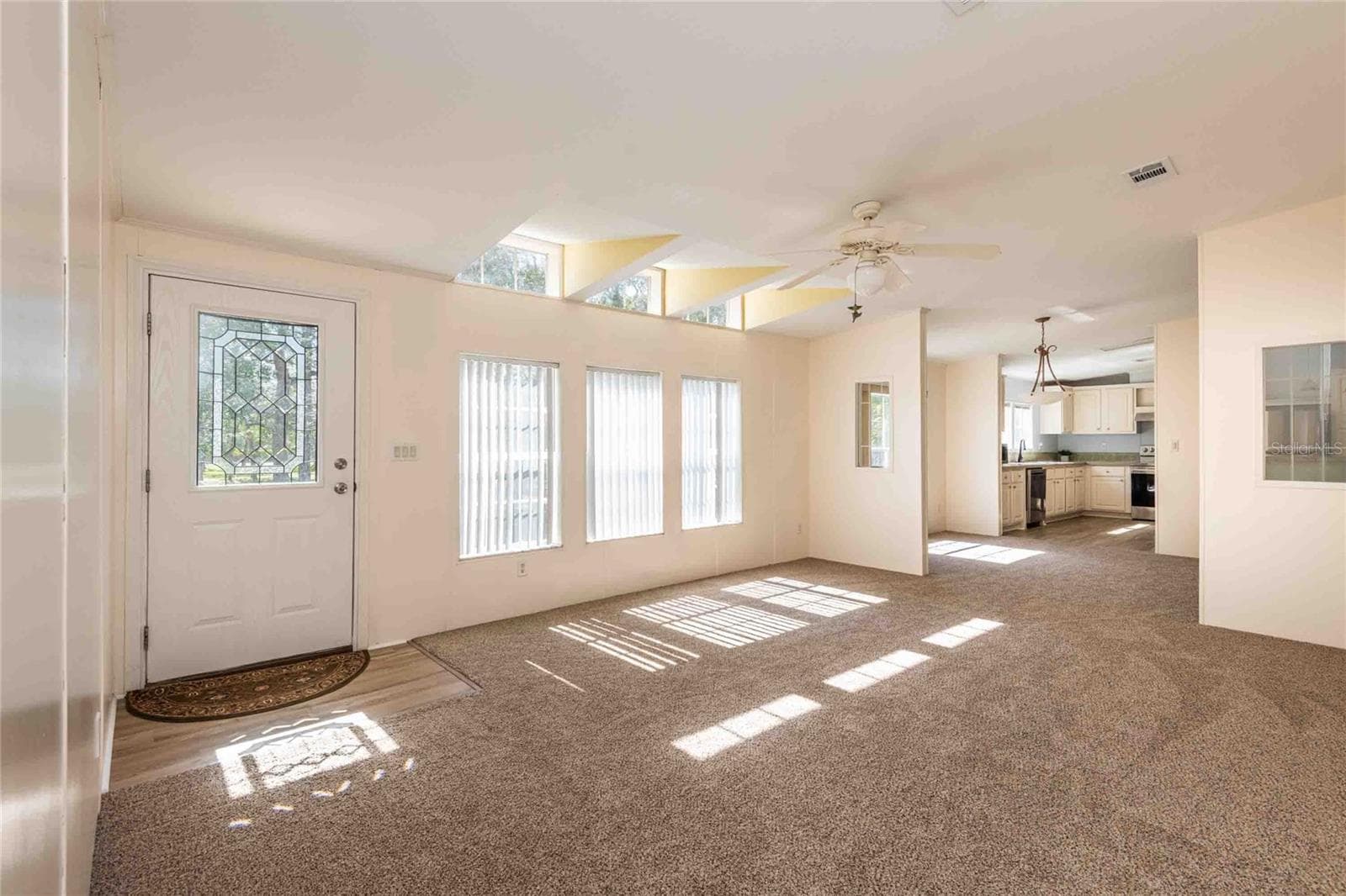 Spacious living room that flows into the dining area, kitchen and great room. - 14221 HURRICANE DR, WEEKI WACHEE